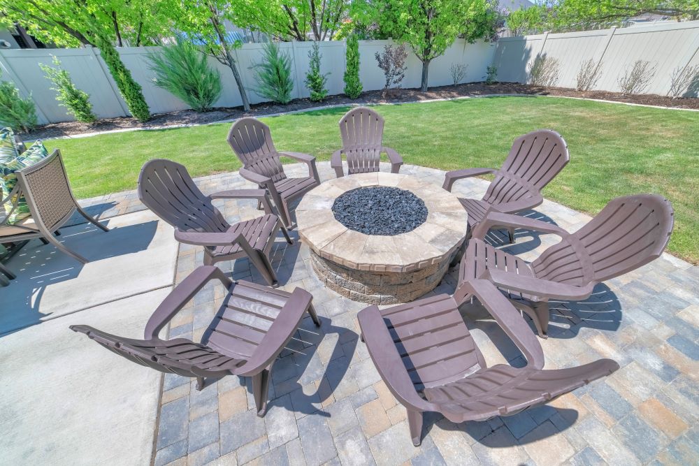 chairs around fire pit in backyard